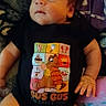 Aidan joined the competition — help win amazing prizes! baby, infant, child, portrait, sitting, lying_down, face, eyes, expression, side_eye, black_onesie, cartoon, food_graphics, blanket, bedding, cozy, indoor, close_up, photography, safe