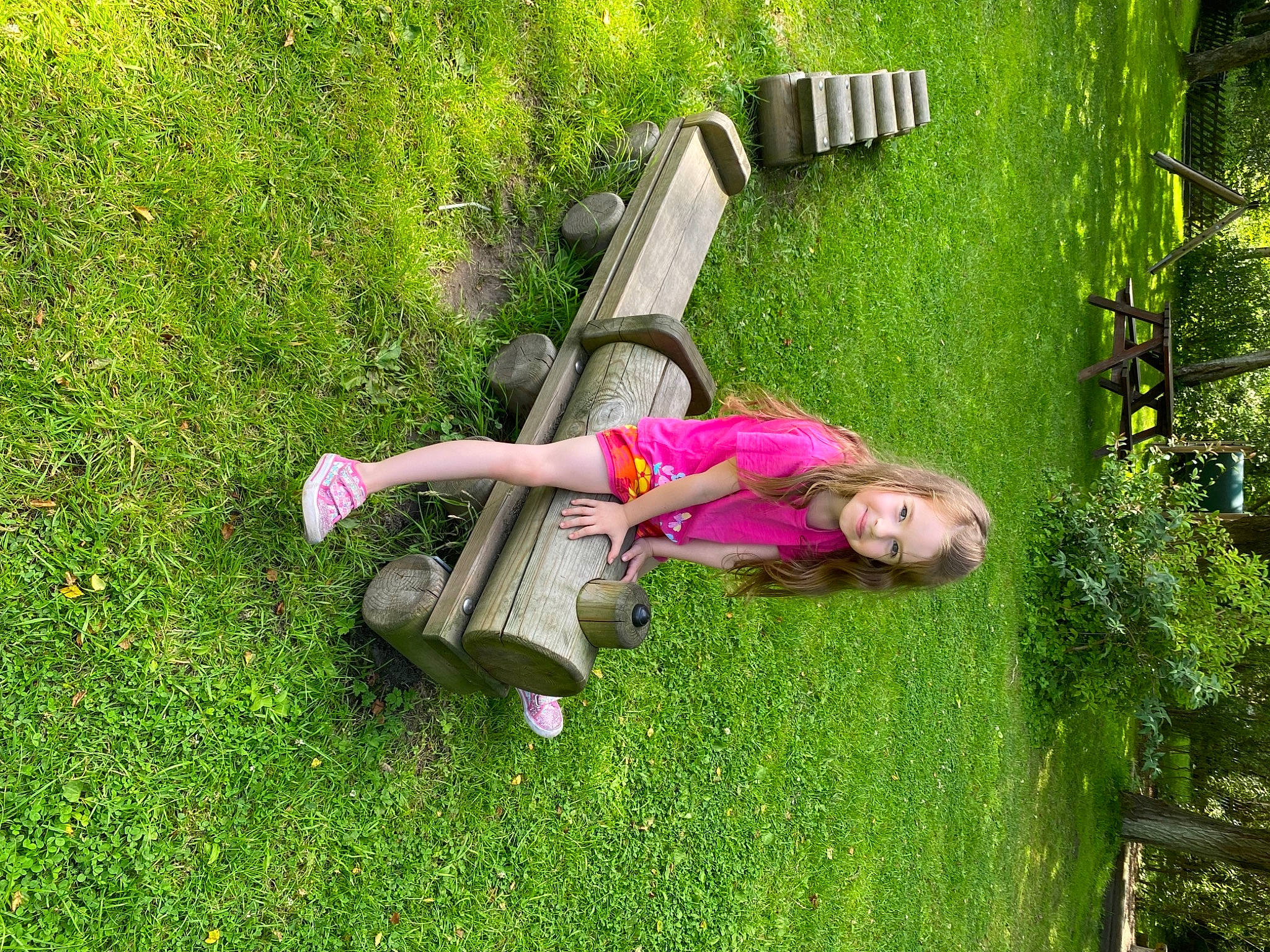Elise Rose Ramsden is registered to the contest to win money with this photo: dress, fun, garden, grass, grass_family, grassland, green, groundcover, joy, landscape, lawn, leisure, magenta, meadow, outdoor_furniture, people_in_nature, person, plant, recreation, shrub