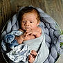 Elie participe au concours pour gagner de l'argent avec cette photo : newborn, baby, blanket, plush_toy, bunny, basket, flowers, wooden_floor, cozy, wrapped, infant, soft_texture, cute, peaceful, portrait, indoor, child, small_feet, knit, resting