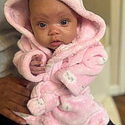 Alani is registered to the contest to win money with this photo: baby, child, clothing, curious, cute, expression, eyes, face, hand, holding, hood, indoor, infant, newborn, person, pink_robe, portrait, skin, soft_texture, warm