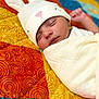 Khaza joined the competition — help win amazing prizes! baby, sleeping, blanket, hat, bunny_hat, quilt, colorful, patterned, face, infant, cozy, soft, cute, child, resting, portrait, indoors, warm, wrapped, peaceful