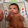 baby, infant, bath, bathseat, polka_dots, wet_hair, hand, expression, skin, chubby, face, eyes, mouth, indoors, person, child, closeup, support, water, bathroom