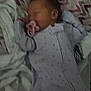baby, sleeping, pacifier, onesie, blanket, pattern, zigzag, infant, child, bed, soft, cozy, resting, cute, wearing, fabric, indoor, peaceful, newborn, toddler