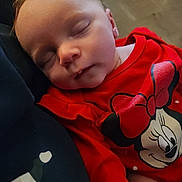 Karissa joined the competition — help win amazing prizes! apparel, baby, cartoon_character, child, closeup, cozy, cute, face, head, human, indoors, infant, minnie_mouse, portrait, red_clothing, resting, sleep, sleeping, soft_light, young_child