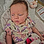 baby, baby_seat, blanket, bunny, child, comfort, cushion, cute, floral_pattern, indoors, infant, onesie, person, plush_toy, relaxing, resting, sleepy, soft_toy, wearing_clothes, young_child