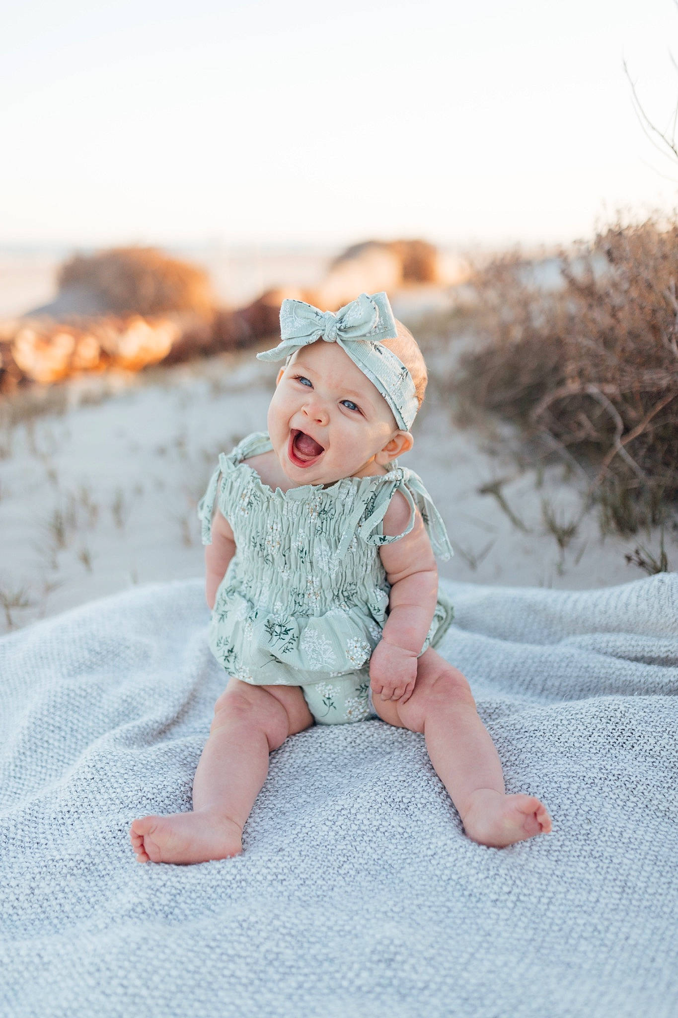 Addisyn is registered to the contest to win money with this photo: baby, baby_toddler_clothing, child, fashion_accessory, flash_photography, fun, grass, happy, hat, headgear, headwear, landscape, ocean, people_in_nature, person, portrait_photography, sand, sitting, sky, sleeve