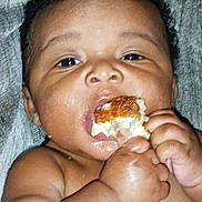 Ma-Kai joined the competition — help win amazing prizes! baby, cheeks, child, closeup, curly_hair, cute, eating, expression, face, fingers, food, hands, indoor, infant, mouth, person, portrait, skin, texture, young