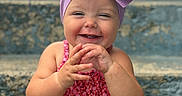 Wrenlee is registered to the contest to win money with this photo: baby, bow, child, concrete, cute, expression, face, floral, hands, happy, headband, outfit, portrait, purple, red, sitting, skin, smiling, stairs, toddler