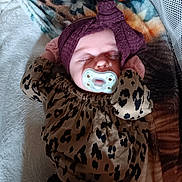 Raylynn joined the competition — help win amazing prizes! baby, sleeping, pacifier, headwrap, blanket, leopard_print, clothing, infant, cozy, pattern, relaxed, cute, indoors, portrait, child, soft_texture, resting, human, toddler, bed