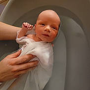 Martin participe au concours pour gagner de l'argent avec cette photo : newborn, baby, infant, bath, water, hand, cloth, wrapped, skin, face, person, toddler, gentle, support, indoors, relaxation, care, sleepy, small, human