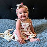 Ariana is registered to the contest to win money with this photo: baby, background, blue_blanket, bunny, cherry_pattern, child, cute, dress, face, fluffy, happy, headband, headwear, indoor, person, plush_toy, portrait, sitting, skin, smiling