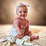 Ariana is registered to the contest to win money with this photo: baby, blanket, bright, bunny, child, cute, happy, headband, indoor, infant, person, pink_top, playful, plush_toy, portrait, sitting, smiling, soft_toy, toddler, white_shorts