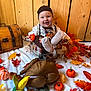 baby, child, pot, metal, pumpkins, autumn, fall, leaves, orange, yellow, plush_toy, turkey, smiling, hat, wooden_background, festive, decorations, white_blanket, cute, happy
