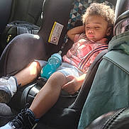 Zaavan is registered to the contest to win money with this photo: black_shoes, car_interior, car_seat, child, clothing, curly_hair, daylight, plaid_shirt, relaxed, seat, seatbelt, shoes, shorts, sippy_cup, sleeping, sunlight, toddler, travel, vehicle, white_shoes