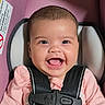 baby, child, infant, smiling, happy, portrait, close_up, face, eyes, open_mouth, teethless_smile, car_seat, safety_harness, buckled, pink_clothing, seated, indoor, photograph, head, joy