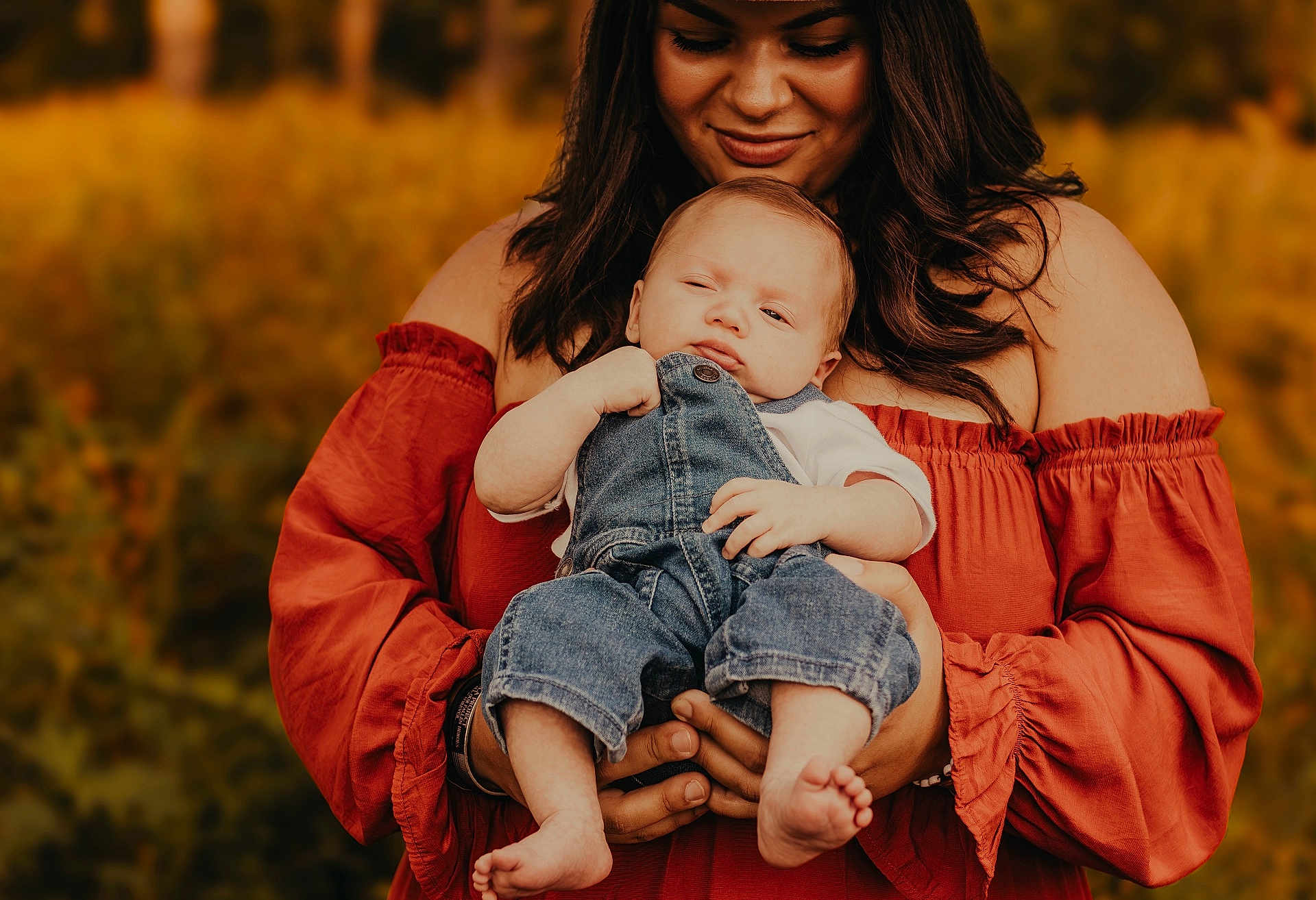 Jaxson J is registered to the contest to win money with this photo: baby, woman, child, outdoor, portrait, denim_overalls, off_shoulder_dress, holding, nature, autumn, warm_colors, smile, person, casual_clothing, barefoot, family, love, tenderness, closeup, happy