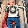 baby, baby_clothes, blue_pants, changing_pad, child, clothing, cute, expression, face, furniture, happy, head, indoor, infant, lying_down, person, smiling, striped_shirt, toddler, towel