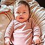 baby, infant, smiling, onesie, striped_clothing, blanket, soft_texture, happy, face, hands, skin, hair, indoor, child, cute, portrait, cozy, relaxed, young, person