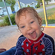 Celica joined the competition — help win amazing prizes! child, toddler, portrait, smiling, tongue_out, silly_face, outdoor, backyard, patio, canopy, swimsuit, mickey_mouse, striped_sleeves, wet_hair, blue_eyes, sitting, residential_street, houses, trees, sunlight