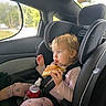 Celica is registered to the contest to win money with this photo: child, toddler, car, car_seat, passenger, sitting, eating, pizza, food, bottle, drink, blonde_hair, blue_eyes, pink_clothing, patterned_pants, seatbelt, vehicle_interior, outdoor_background, portrait, happy