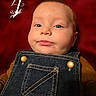 Wren joined the competition — help win amazing prizes! baby, child, infant, portrait, face, smiling, smirk, eyes, head, denim, overalls, clothing, red_background, indoor, close_up, sitting, photography, cute, fashion, person