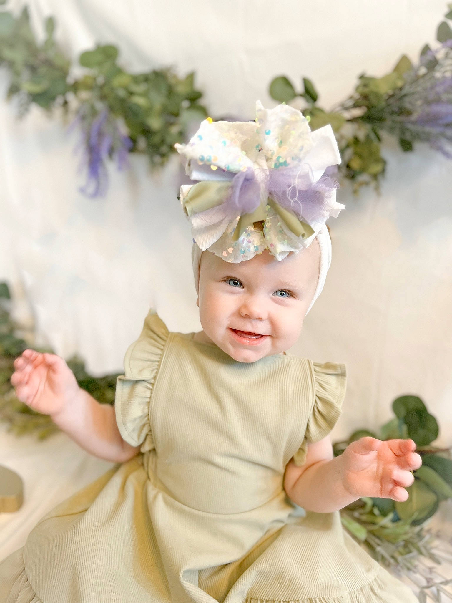 Briar is registered to the contest to win money with this photo: baby, baby_toddler_clothing, costume_hat, crown, event, eye, flower, flower_arranging, happy, headband, headgear, headpiece, headwear, jewellery, person, petal, pink, plant, smile, toddler