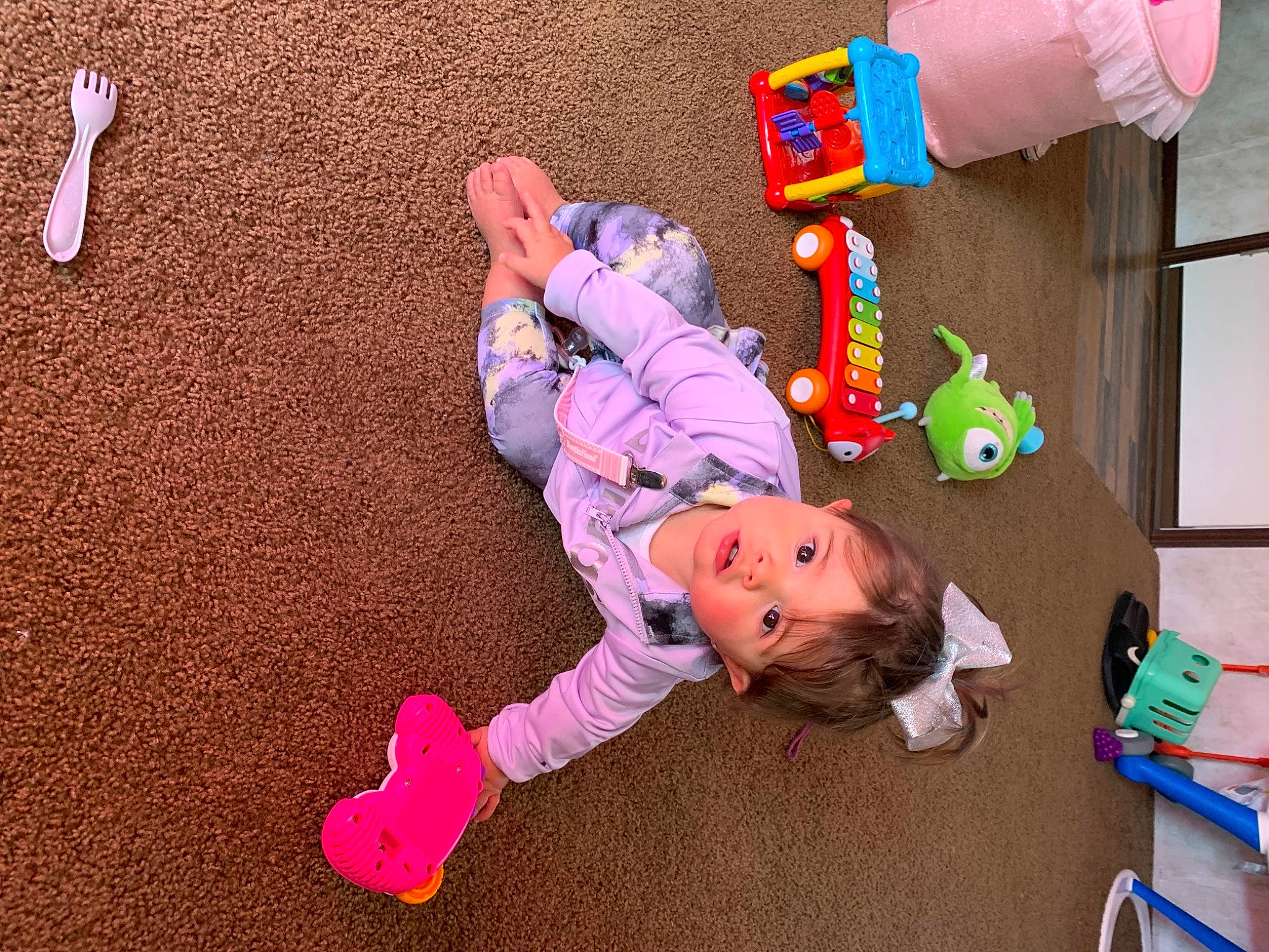 Juliette joined the competition — help win amazing prizes! baby_toddler_clothing, child, floor, flooring, fun, happy, leisure, magenta, person, pink, play, room, sitting, toddler, toy, wood