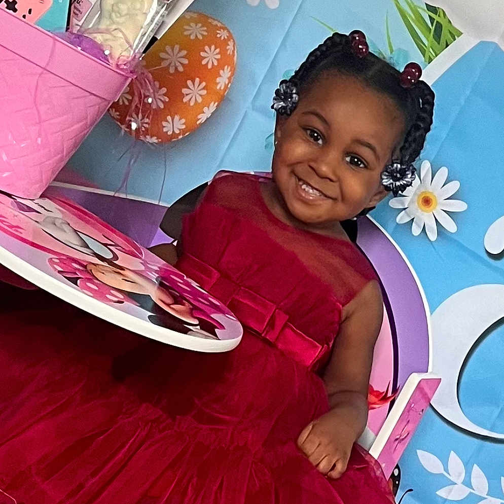 Kaylen is registered to the contest to win money with this photo: birthdaycake, chair, child, clothing, couch, cushion, dress, face, female, furniture, girl, happy, head, homedecor, person, photography, portrait, purple, sitting, smile