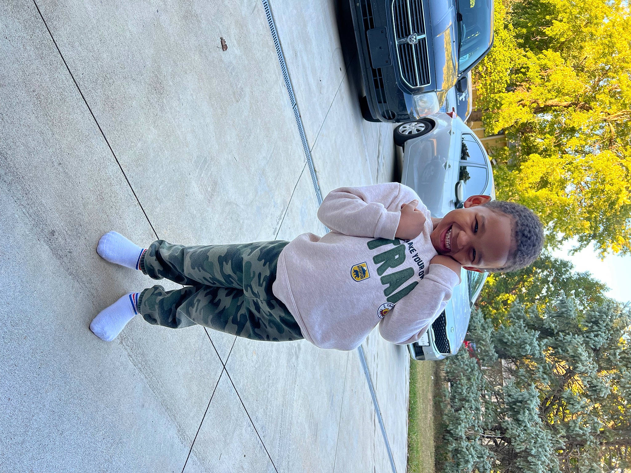 Karter joined the competition — help win amazing prizes! automotive_exterior, automotive_lighting, car, electric_blue, family_car, fun, joy, leisure, motor_vehicle, outdoor_shoe, person, plant, recreation, sky, snapshot, tire, toddler, tree, vehicle, vehicle_door