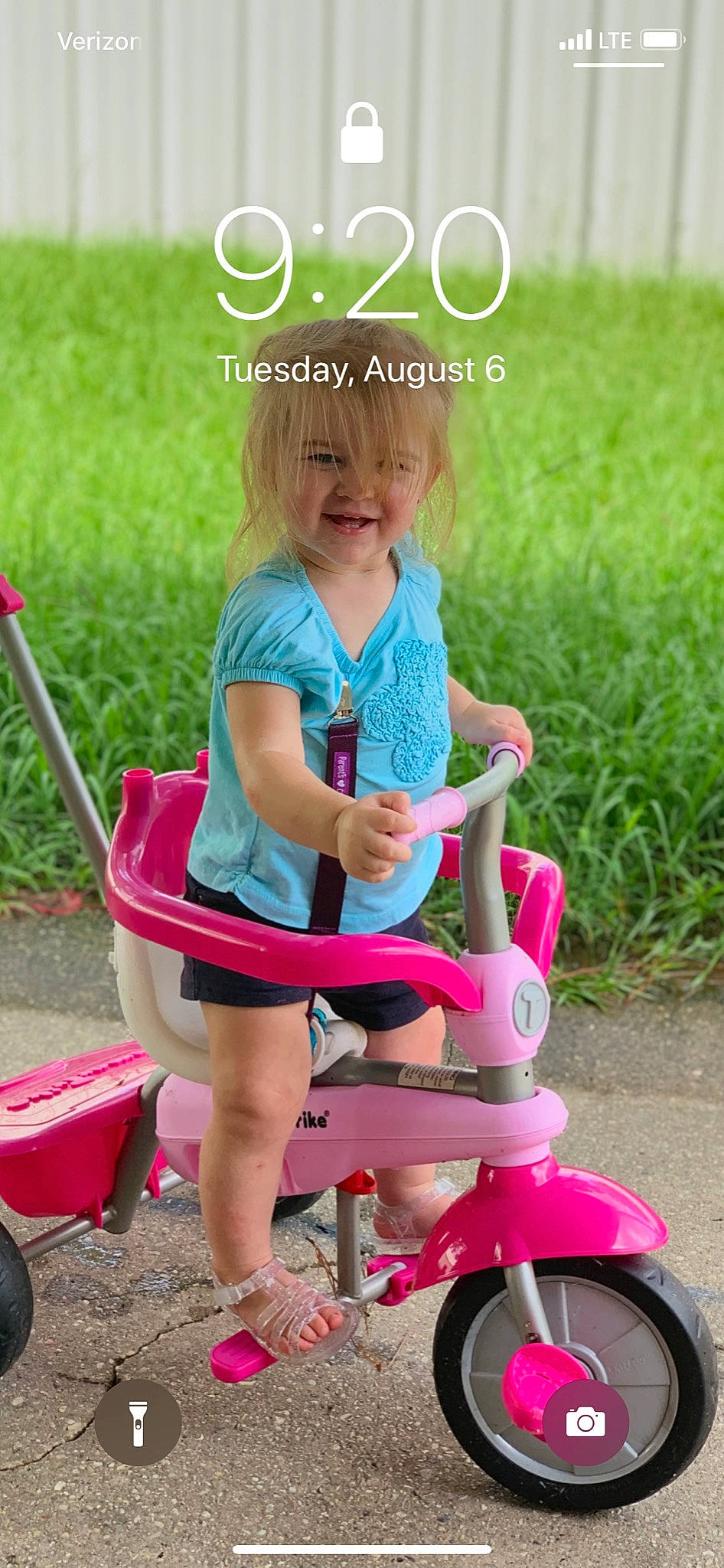 Ella is registered to the contest to win money with this photo: child, fun, joy, leisure, person, photo_caption, pink, play, playground, product, public_space, recreation, riding_toy, sitting, summer, toddler, tricycle, vehicle, wheel