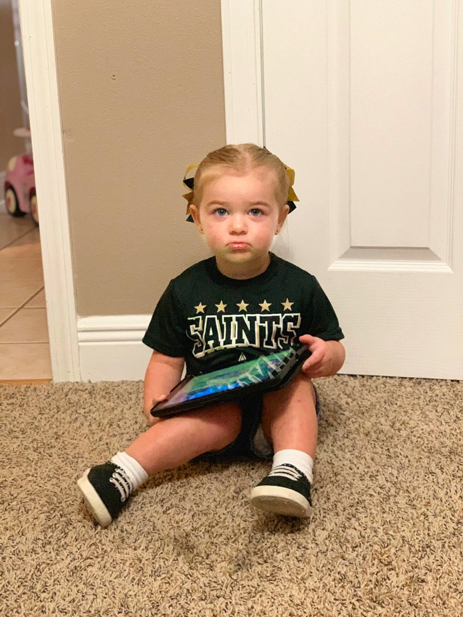 Ella is registered to the contest to win money with this photo: arm, baby, blue, child, floor, flooring, footwear, joint, knee, leg, person, play, room, shoe, shoulder, sitting, skin, standing, t_shirt, toddler