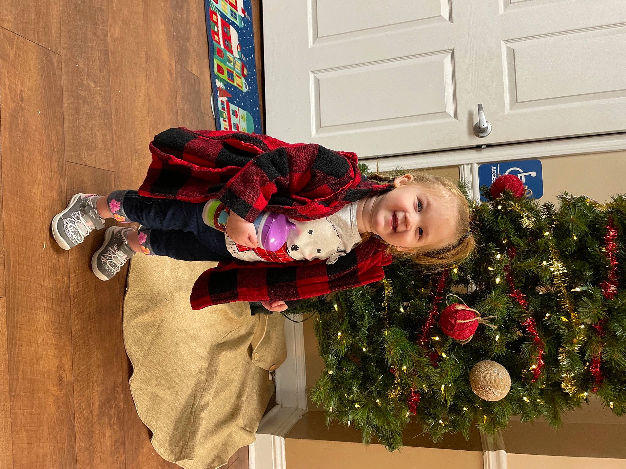 Lorelai joined the competition — help win amazing prizes! boot, carmine, christmas, christmas_decoration, christmas_eve, christmas_ornament, christmas_tree, conifer, event, fun, holiday, holiday_ornament, ornament, person, plant, room, smile, toddler, tradition, tree