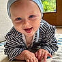 baby, infant, crawling, smiling, striped_clothing, blue_hat, carpet, indoor, face, hands, cute, child, happy, person, floor, home, playing, bright_eyes, closeup, natural_light
