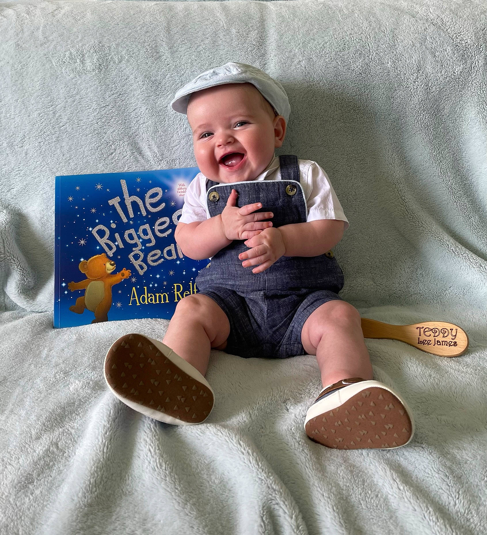 Theo is registered to the contest to win money with this photo: baby, baby_toddler_clothing, cap, comfort, fedora, finger, happy, hat, headwear, knee, lap, person, shorts, sleeve, smile, sneakers, sock, sun_hat, t_shirt, textile