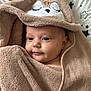 Esmée participe au concours pour gagner de l'argent avec cette photo : baby, infant, towel, hooded_towel, face, blue_eyes, blanket, star_pattern, soft_texture, cute, smile, wrapped, child, newborn, bed, sleepy, cozy, skin, person, portrait