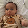 baby, infant, pajamas, pumpkin, cute, wide_eyes, lying_down, blanket, bed, soft, expression, child, indoors, sleepwear, face, person, comfort, holiday_theme, autumn, surprised