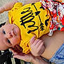 Laynie is registered to the contest to win money with this photo: baby, child, blue_eyes, yellow_shirt, floral_shorts, hand, bench, person, outdoor, clothing, cute, face, skin, infant, holding, resting, casual, summer, portrait, young