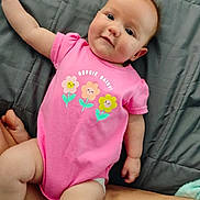 Laynie is registered to the contest to win money with this photo: baby, infant, pink_onesie, flower_graphic, text, gray_quilt, arm, skin, cute, chubby_cheeks, laying_down, indoor, child, person, apparel, soft_lighting, casual, closeup, happy, young