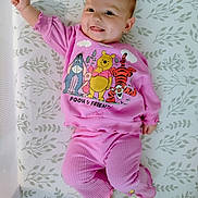 Laynie joined the competition — help win amazing prizes! baby, infant, smiling, pink_clothing, winnie_the_pooh, tiger, eeyore, piglet, lying_down, mattress, patterned_bedding, cute, happy, child, portrait, indoors, sleepwear, raised_arm, small_feet, cheerful