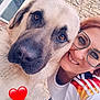 dog, person, glasses, smiling, outdoor, closeup, affection, heart_emoji, white_shirt, red_hair, stone_wall, pet, companion, friendship, portrait, canine, happy, casual_clothing, eyewear, love