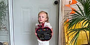 Jaden joined the competition — help win amazing prizes! child, concrete, curious, decoration, door, face, footwear, green, halloween, house, orange, plant, porch, shirt, shorts, sign, welcome_mat, window, wreath, yellow