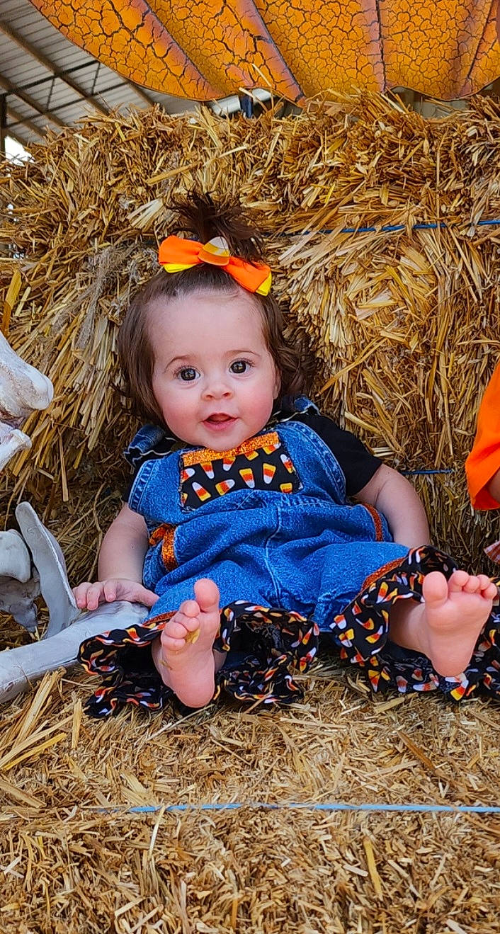 Kimber is registered to the contest to win money with this photo: autumn, baby, baby_toddler_clothing, child, doll, eye, fawn, fun, grass, happy, head, iris, people_in_nature, person, portrait_photography, sitting, soil, straw, toddler, toy