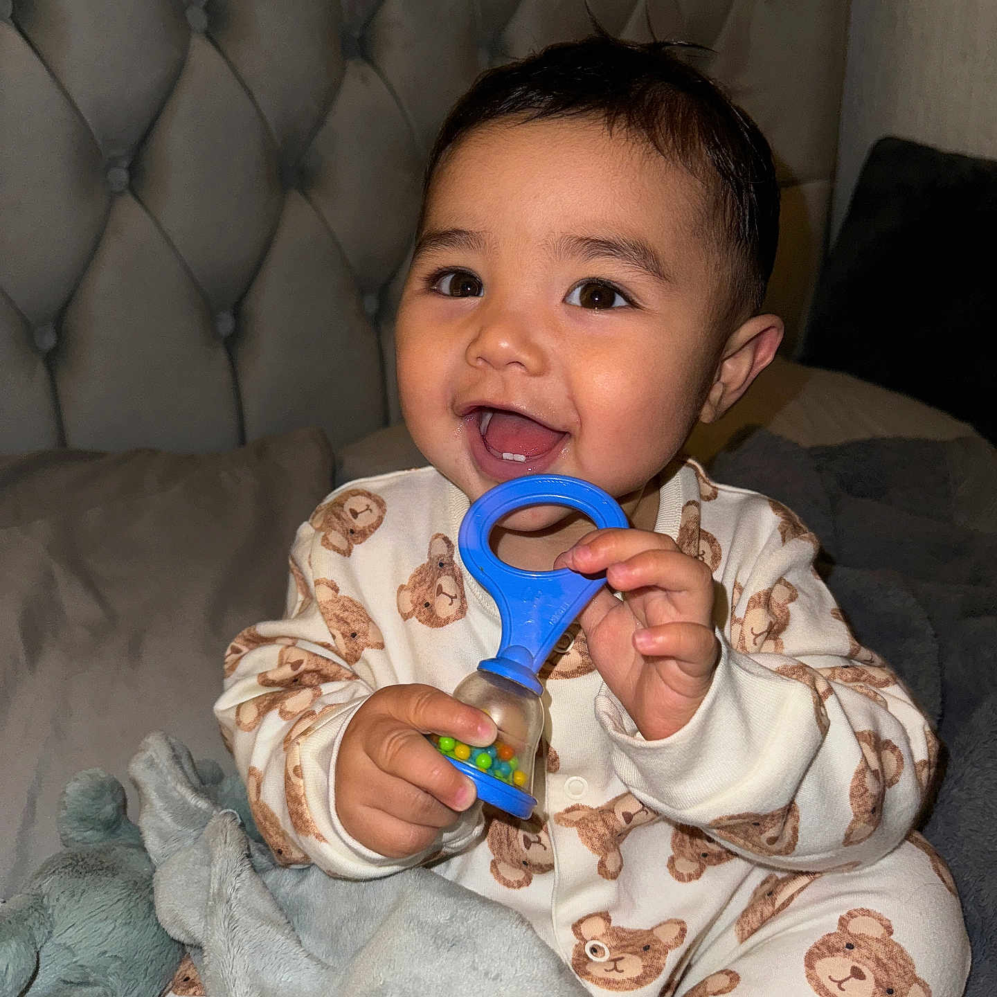 Elias is registered to the contest to win money with this photo: baby, blanket, bodypart, couch, cream, cutlery, eating, face, finger, food, furniture, hand, head, mouth, person, photography, portrait, quilt, sitting, spoon