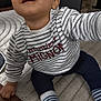 baby, child, striped_shirt, socks, floor, rug, indoor, curious, smiling, person, crawling, clothing, cute, portrait, casual, young, infant, happy, home, reaching