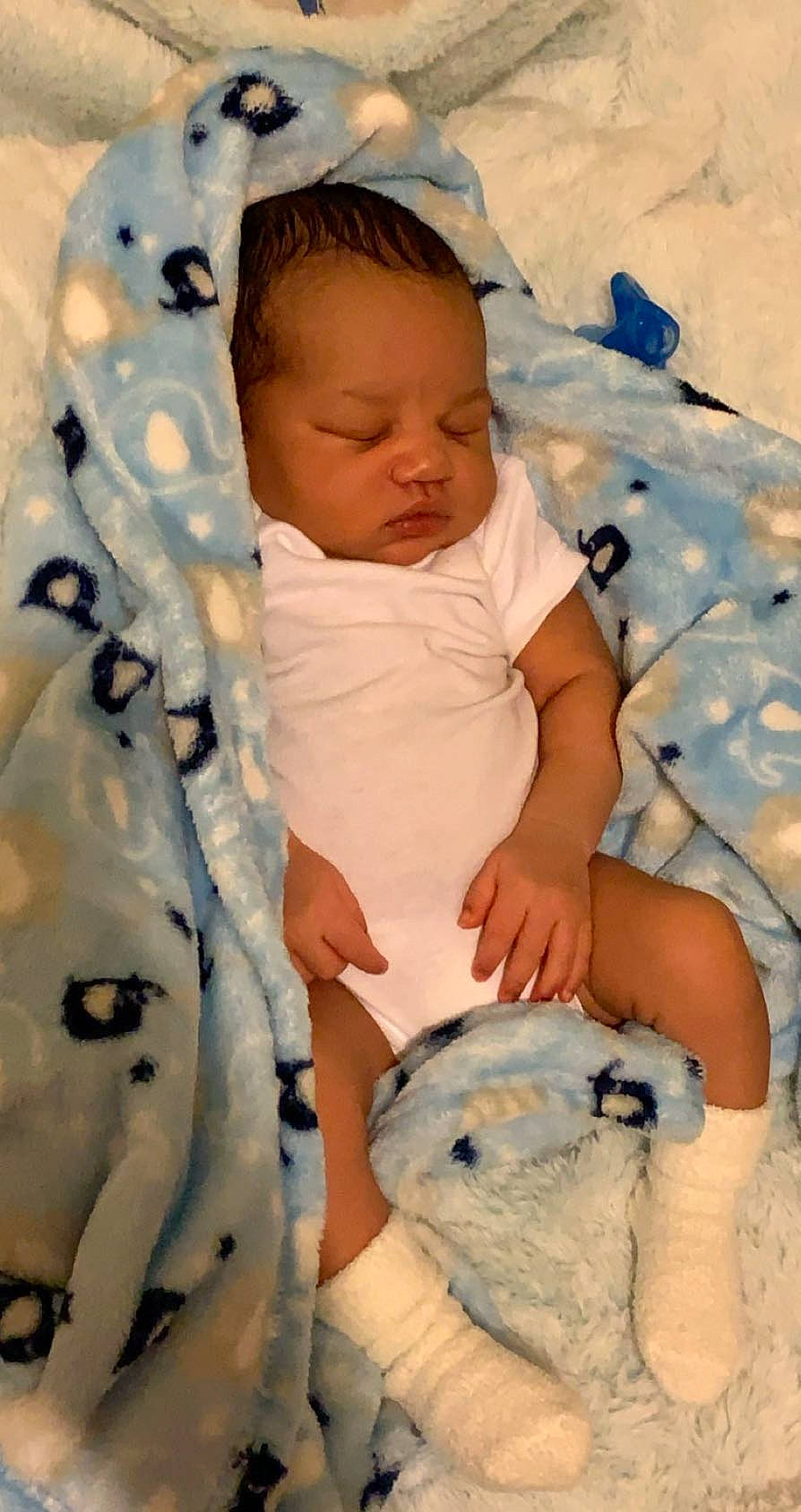 Deangelo is registered to the contest to win money with this photo: baby, baby_products, baby_sleeping, baby_toddler_clothing, comfort, linens, person, sleep, snow, toddler