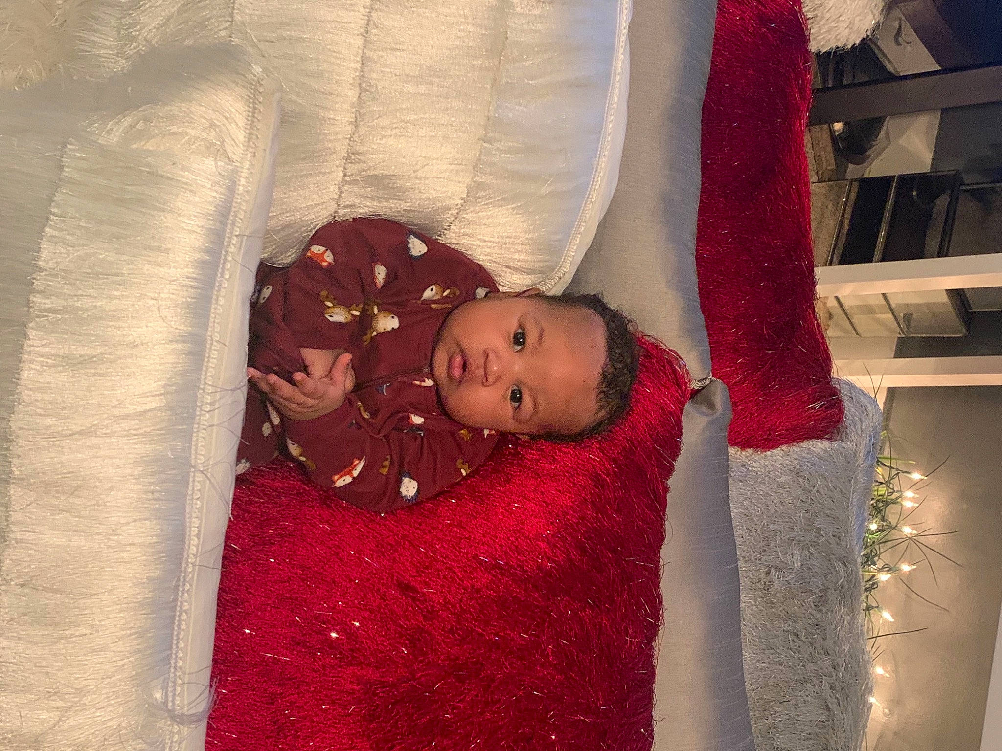 Deangelo is registered to the contest to win money with this photo: baby, baby_toddler_clothing, comfort, linens, maroon, person, red, shelf, shelving, textile
