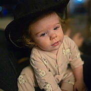 Brooklyn joined the competition — help win amazing prizes! toddler, child, hat, pajamas, bunny_print, cute, indoor, portrait, baby, face, eyes, hands, feet, soft_lighting, cozy, curly_hair, person, casual_clothing, sitting, blurred_background