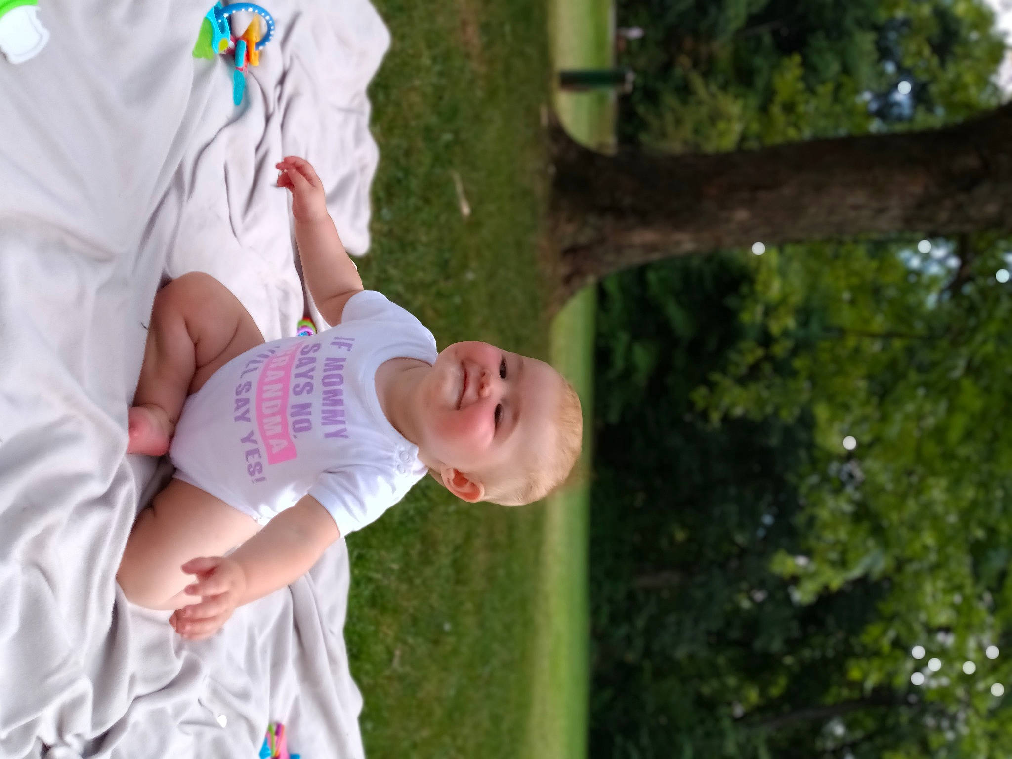 Jenevieve is registered to the contest to win money with this photo: baby, baby_toddler_clothing, child, event, family, fun, gesture, grass, happy, hat, joy, leisure, love, people_in_nature, person, recreation, sleeve, summer, t_shirt, toddler