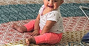 Aurorabelle is registered to the contest to win money with this photo: baby, barefoot, carpet, child, clothing, happy, home, indoors, infant, patterned_blanket, photography, pink_pants, play_mat, playroom, portrait, sitting, smiling, storage_bins, toy_storage, white_shirt