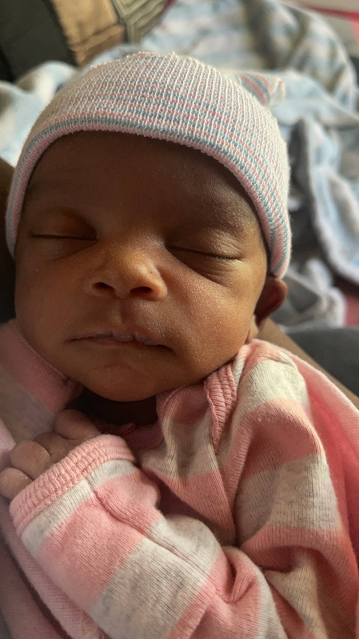 Amarah is registered to the contest to win money with this photo: baby, cap, cheek, child, chin, comfort, eye, eyebrow, facial_expression, finger, gesture, headwear, human, lip, mouth, nose, person, pink, product, skin